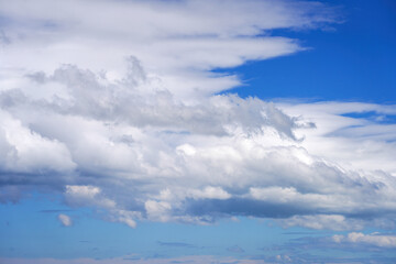 Blue sky with clouds of different shapes. Cloudy overcast sky.