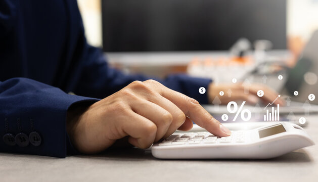 close up accountant employee man hand press on calculator to calculate about commission rate form company's project after dealing contract from client in office room for business lifestyle concept