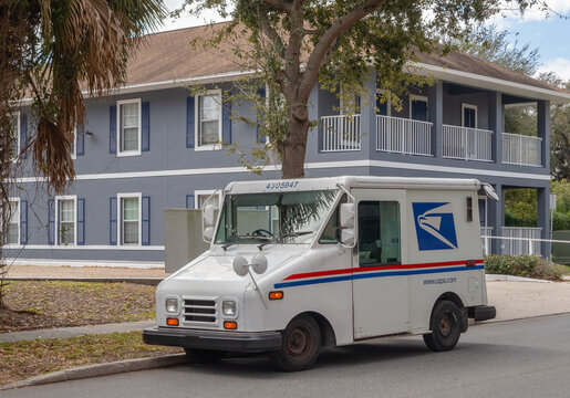 USPS mail truck delivering mail in neighborhood. Kissimmee, FL, USA, 2-10-24. 