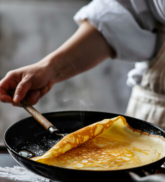 Pancake being flipped in the pan