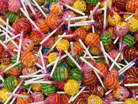 Poznan, Poland - 08.03.2024: Brightly colored candy on a stick chupa chups close-up. Background of colorful candy chupa chups. Texture of chupa chups candies