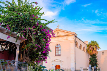 Catholic church near blooming bougainvillea. The old town of Rethymnon is one of the best-preserved towns of the Renaissance.