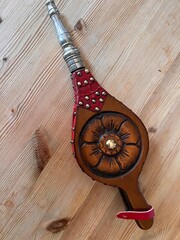 Close up of fire bellows, the vintage fireside tool made of wood and leather with brass stud...