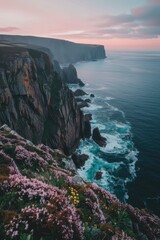 Obraz premium Stunning Cliffs Overlooking Vibrant Blue Sea at Twilight