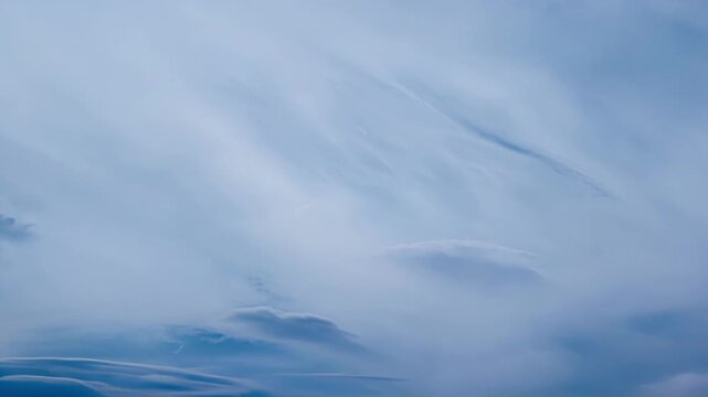 The sky is filled with an abundance of soft cirrus clouds their wispy formations creating a heavenly scene above.