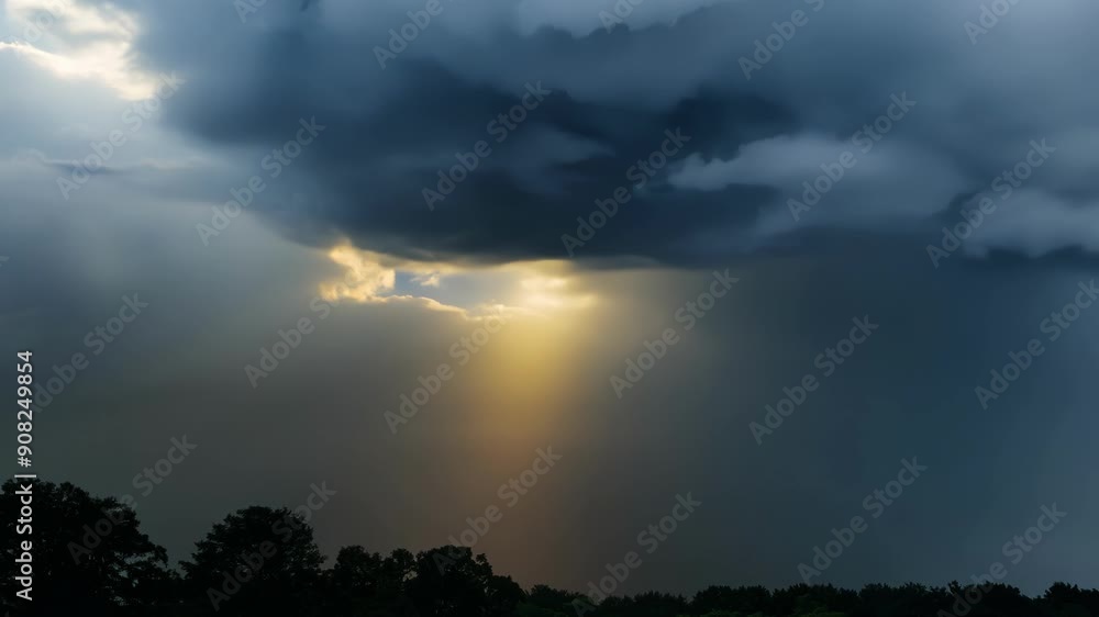 Poster a closeup of dark storm clouds shifting and changing eventually breaking apart to reveal rays of sun