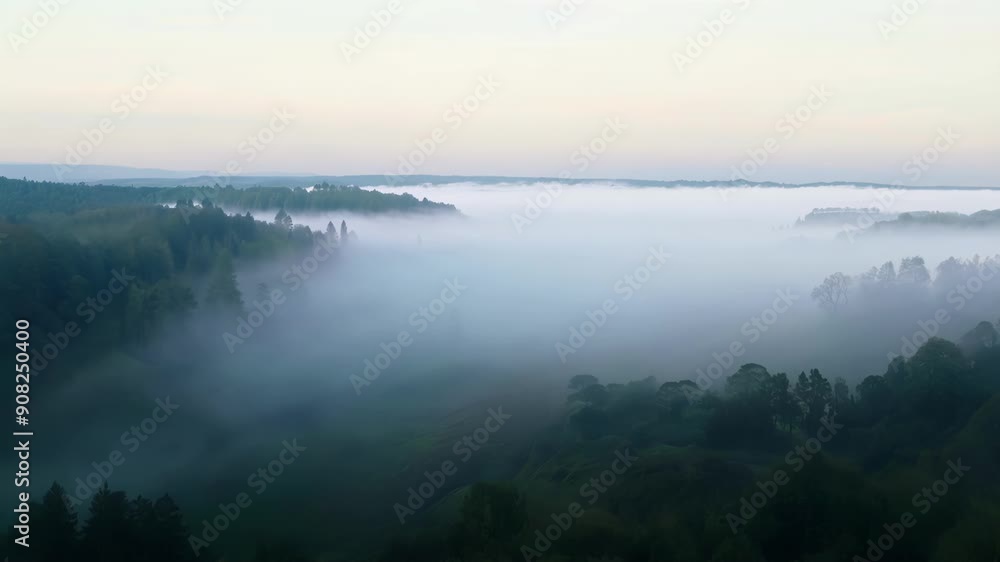 Aufkleber wispy clouds of fog rolling in and enveloping a quiet valley.