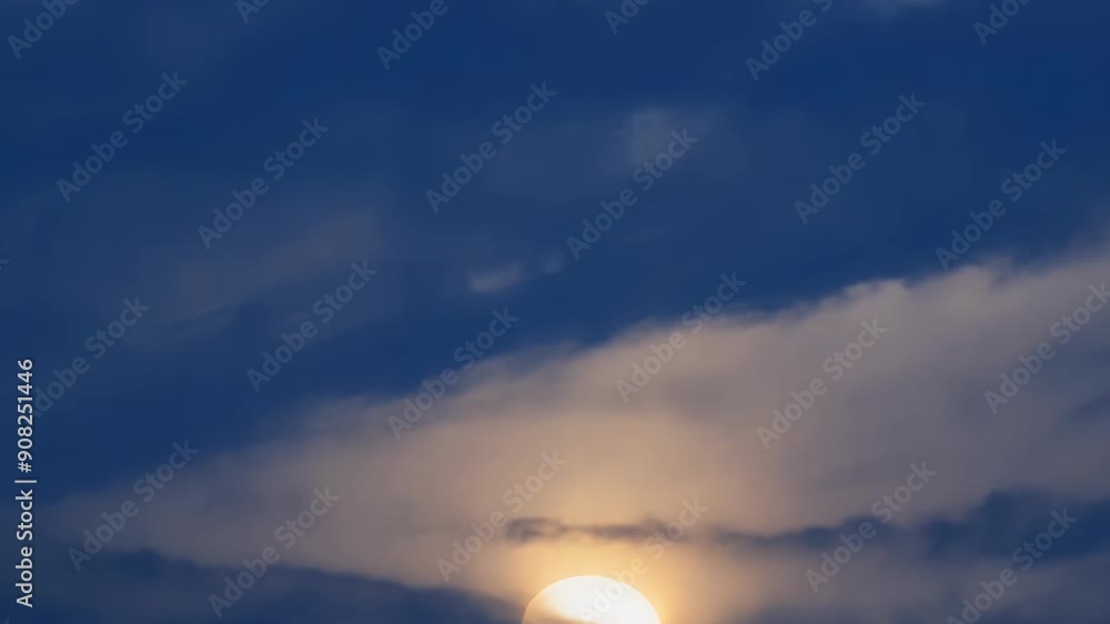 Poster the mesmerizing sight of the eclipsed sun behind wispy clouds adding a touch of mystique to the cele