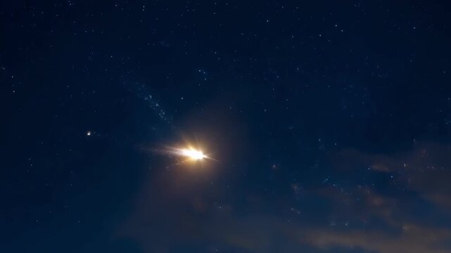 Marveling at the stunning trail of a meteor as it descends gracefully and leaves behind a trail of shimmering stardust.