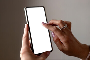 Hand of Woman holding a mobile phone with blank screen for mockup.
