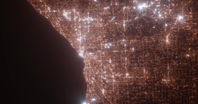 Cleveland (Ohio, USA) aerial view at night. Top view on modern city with street lights. Camera is zooming out, rotating counterclockwise. Vertical video. The north is on the left side