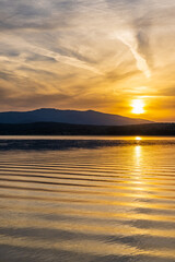 Romantic summer sunset on the beach by the lake