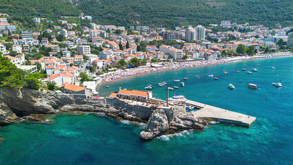 Aerial view of the Kastio Castle built on a peninsula in Petrovac na Moru, a resort town located on the coast of the Adriatic Sea in Montenegro
