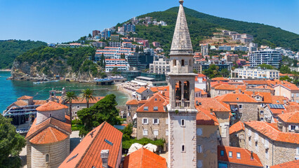 Obraz premium Aerial view of the Holy Trinity Church in the Old Town of Budva, built on a peninsula along the coast of the Adriatic Sea in Montenegro