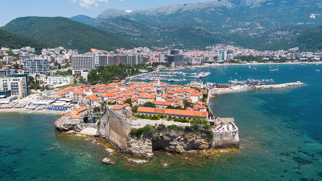 Aerial view of the Old Town of Budva, built on a peninsula along the coast of the Adriatic Sea in Montenegro - Walled coastal city built by the Venetian Republic