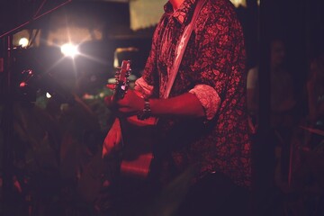 Guitarist on stage and sings at a concert for background, soft and blur concept