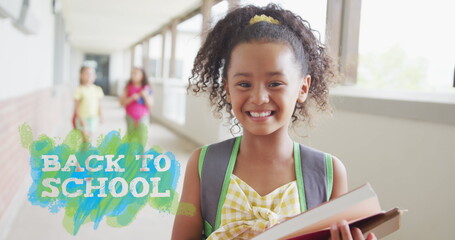 Image of back to school text over happy biracial schoolgirl at school