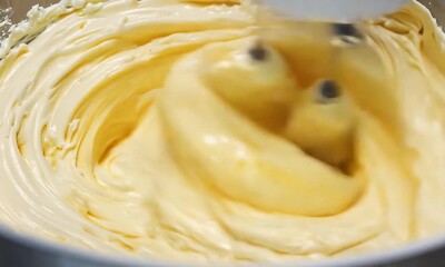 Whipping Up Sweetness: Electric mixer blends a creamy batter in a white bowl, promising a delicious treat. 