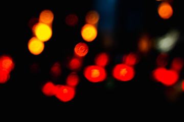 A blurry image of a car with red lights. The lights are scattered throughout the image, creating a sense of movement and energy. Scene is dynamic and exciting