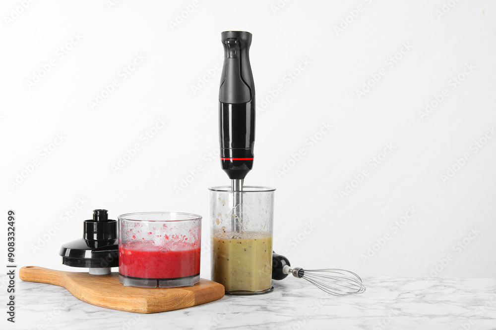 Sticker Hand blender kit and mixtures of ingredients on white marble table, space for text