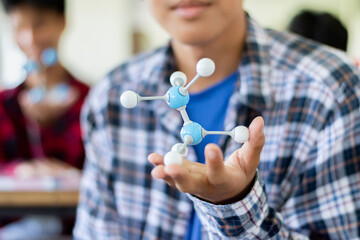 Students are studying simulate shape of covalent molecules by connecting molecular function shapes...