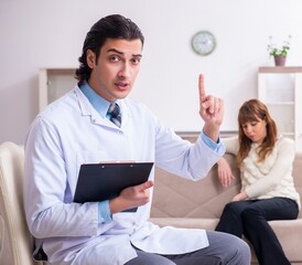 Young female patient discussing with male psychologist personal