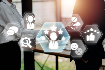 Business professionals shaking hands with customer experience icons overlay, symbolizing service...