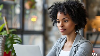 Focused african american casual businesswoman using laptop sitting at desk in office copy space : Generative AI