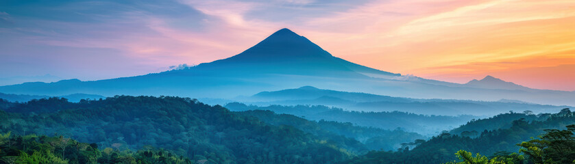 Fototapeta premium Stunning sunrise over a mountain with lush green forests, vivid sky colors blending beautifully. Serene landscape view creating a peaceful and tranquil atmosphere.