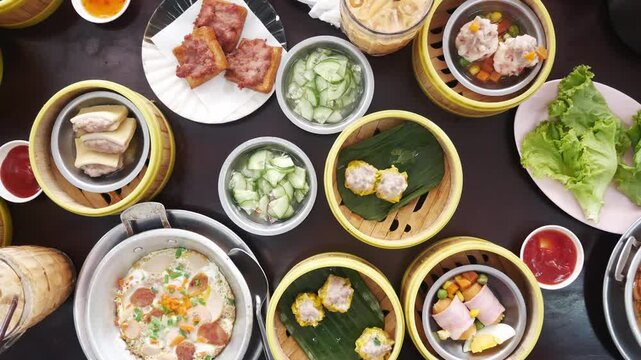 top down view to table full with streamers with dumpling dimsum for morning breakfast chinese meal,shu mai Chinese hong kong style breakfast food steamed dumplings stuffed meat