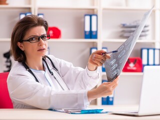 Aged female doctor radiologist in the clinic