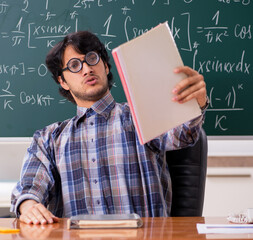 Funny male math teacher in the classroom