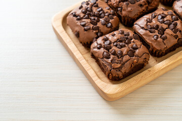 dark chocolate brownies topped by chocolate chips