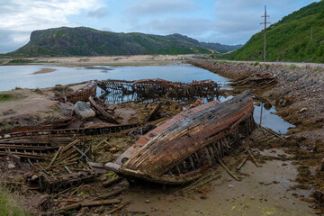 On the cemetery of old ships on a cloudy July day. Teriberka. Murmansk region, Russia
