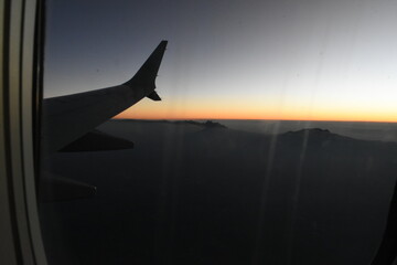 airplane landing at sunset