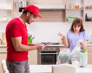 Young male courier in food delivery concept