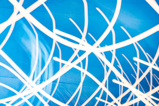 The image is a blue and white abstract piece with many white lines. The lines are arranged in a way that creates a sense of movement and energy