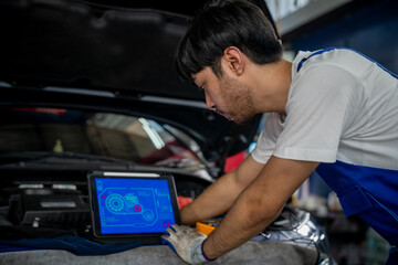 Professional Auto Mechanic Using Digital Tablet for Vehicle Inspection and Maintenance in Modern Automotive Garage