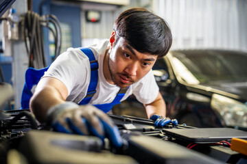 Professional Auto Mechanic Conducting Vehicle Inspection and Maintenance in a Modern Automotive Garage
