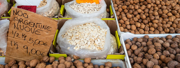 Street market stalls with dried legumes, Rome, Italy