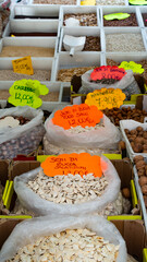 Street market stalls with dried legumes, Rome, Italy