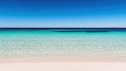 Fototapeta premium A tranquil beach features crystal-clear waters merging with the bright blue sky