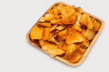 Grain crisp tortilla nacho chips serving on wooden plate. isolated on white background. Mexican traditional food.