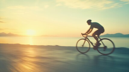 Fototapeta premium A cyclist enjoys a scenic ride along the road as the sun sets over the tranquil sea