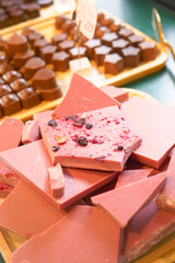 Wooden tray with magenta chocolate on a table at the event