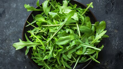 A plate of fresh arugula leaves.
