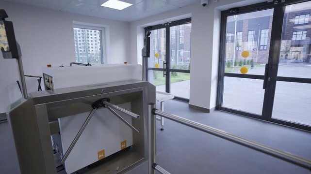 Turnstiles at checkpoint equipped with biometric scanners providing secure entry process. Checkpoint includes series of security gates