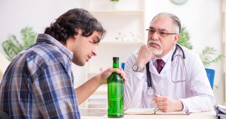 Young male alcoholic visiting old doctor