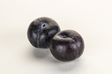Two ripe sweet black plums