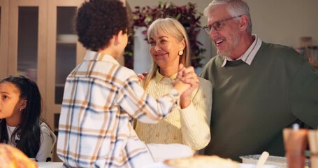 Happy, senior and grandparents play with child on table for thanksgiving lunch, fun game and bonding together. Smile, interracial family and boy with brunch reunion, care and love for trust at house